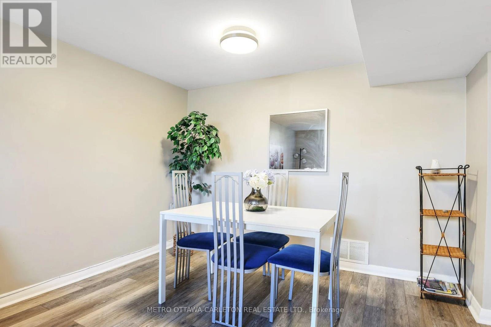 A dining room with a white table and blue chairs.