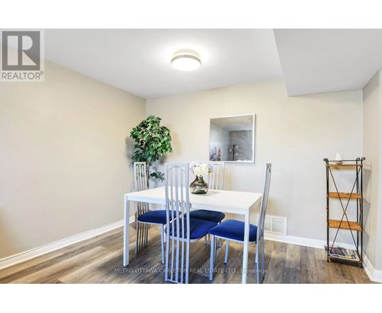 A dining room with a white table and blue chairs.