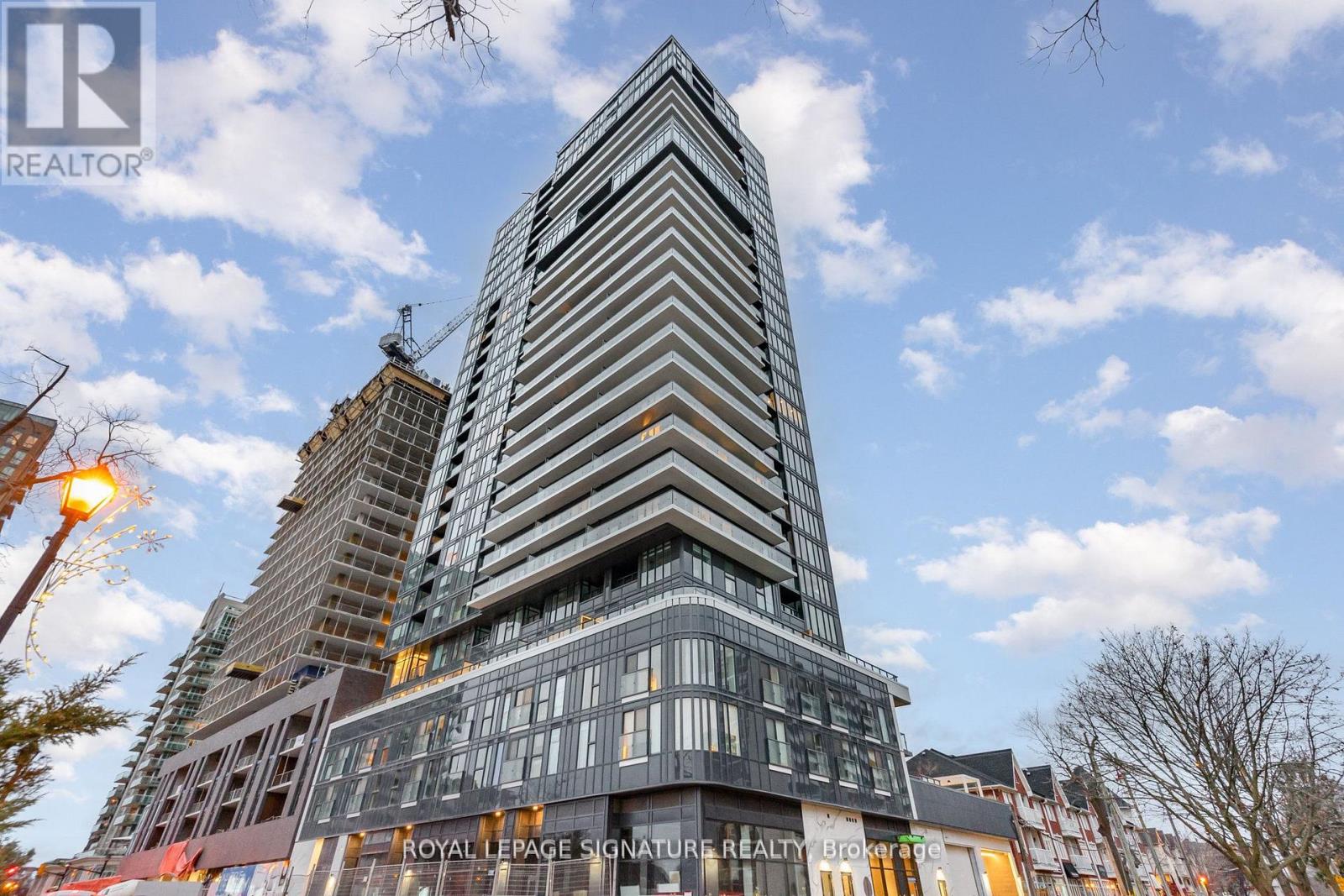 A tall building with a sign that says "Royal LePage Signature Realty" in front of it.