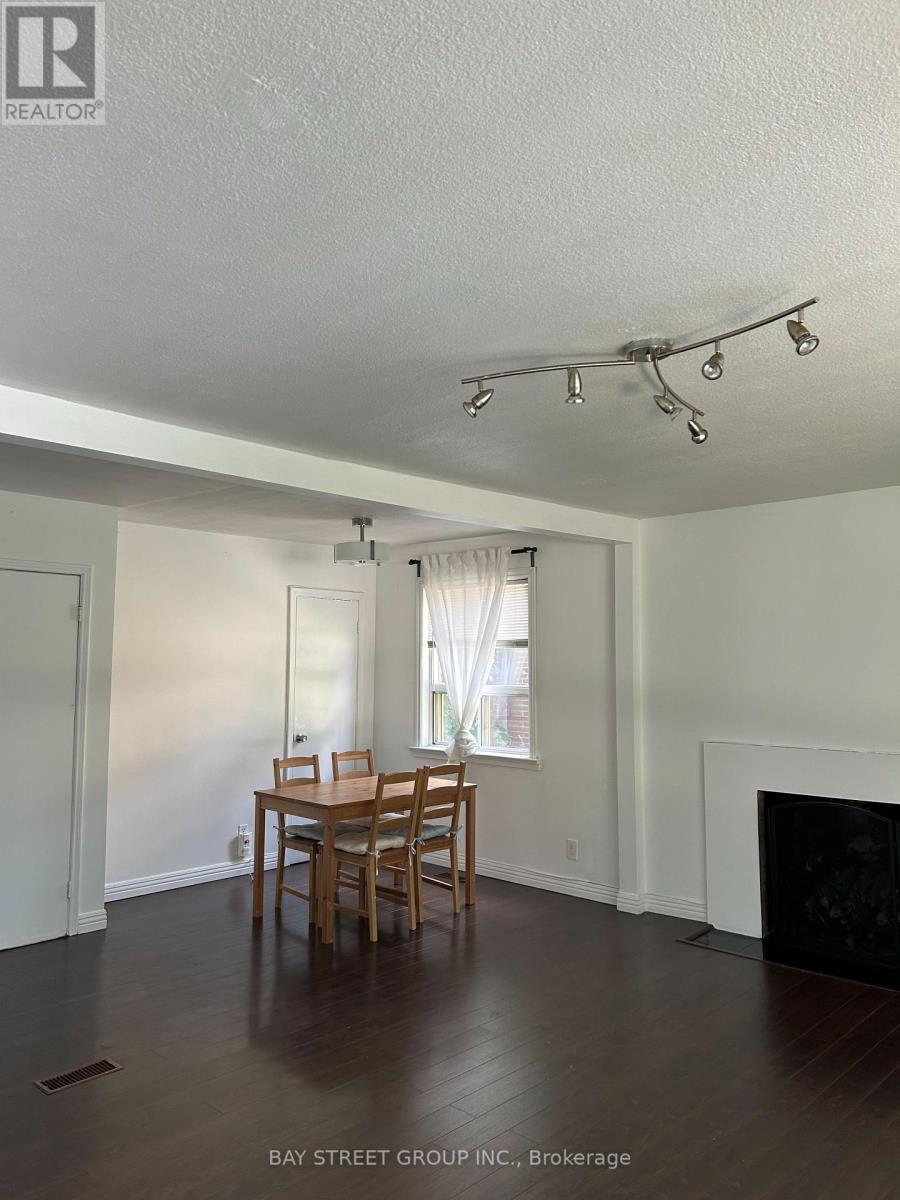 A dining room with a table and chairs.