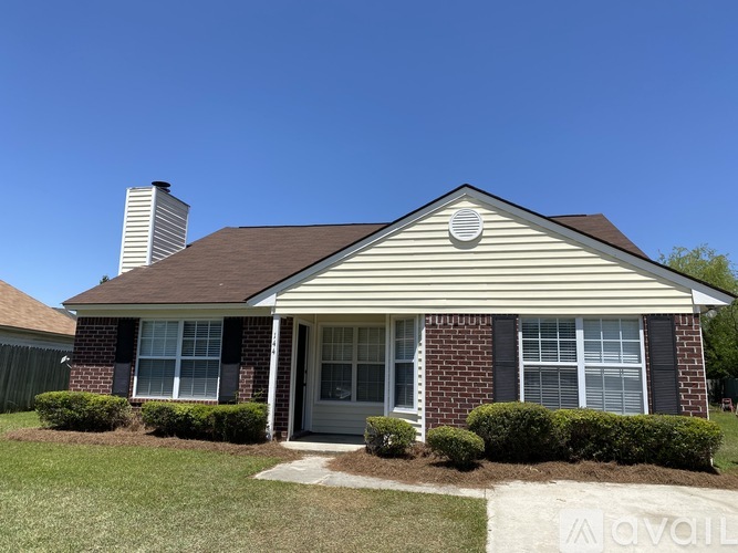 A house with a brick facade and a grey roof.