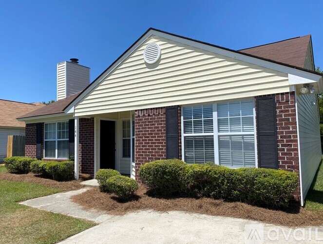 A house with a red brick exterior and a white roof.