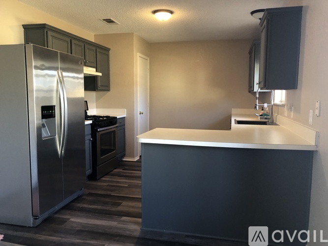 A kitchen with a stainless steel refrigerator and a countertop.