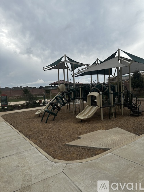 A playground with a slide and a climbing frame.