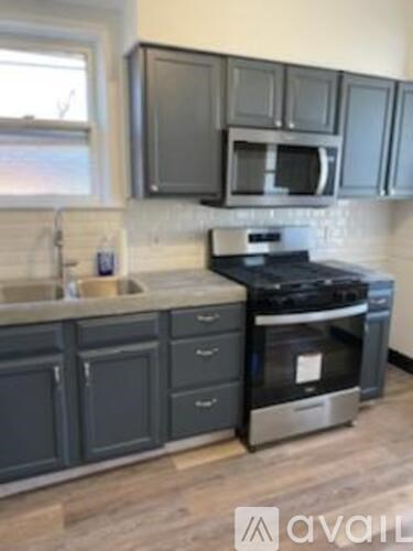 A kitchen with a stove top oven and microwave above it.