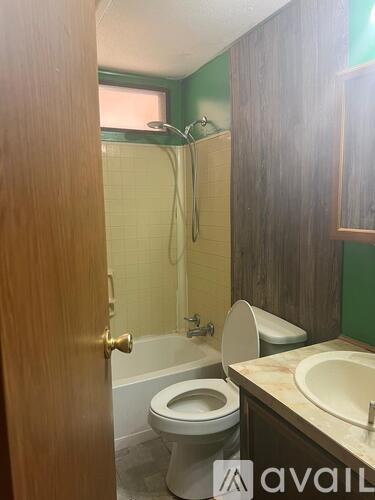 A bathroom with a toilet, sink, and bathtub.