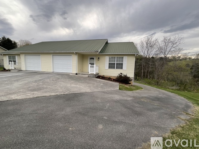 A two-story house with a garage and a driveway.