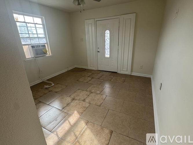 A room with a tiled floor and a door with a glass window.