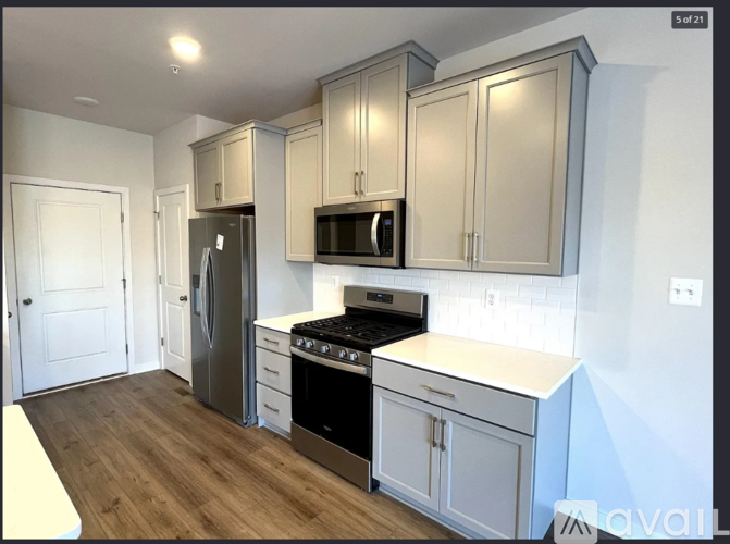 A kitchen with a stove top oven and a microwave above it.