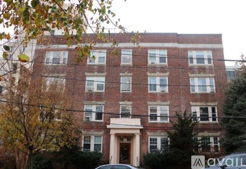 A brick building with a white door and windows.