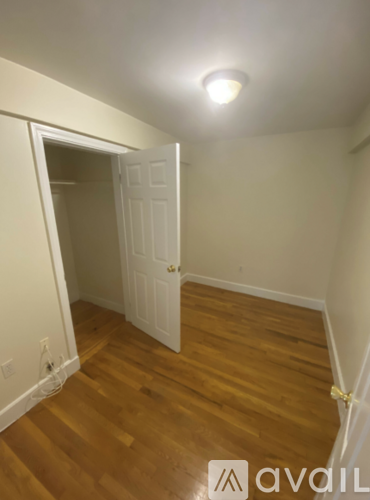 A room with a wooden floor and a white door.