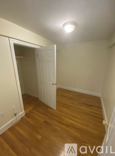 A room with a wooden floor and a white door.