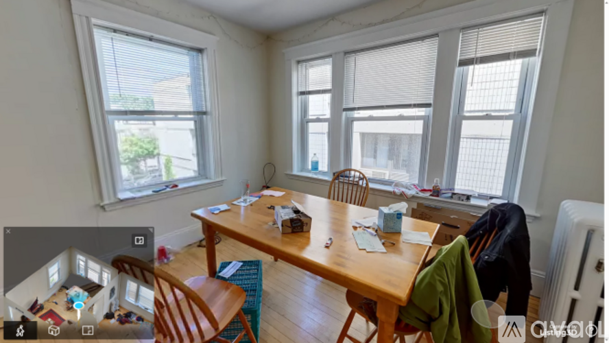 A room with a table, chairs, and a window.