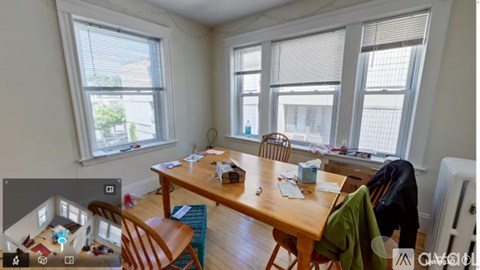 A room with a table, chairs, and a window.
