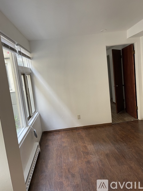 A room with a window and a door.