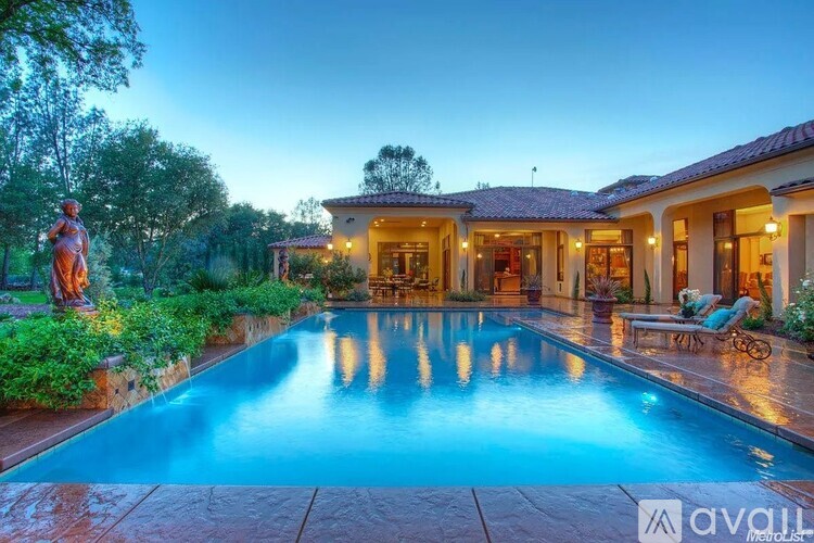 A large house with a pool in the backyard.