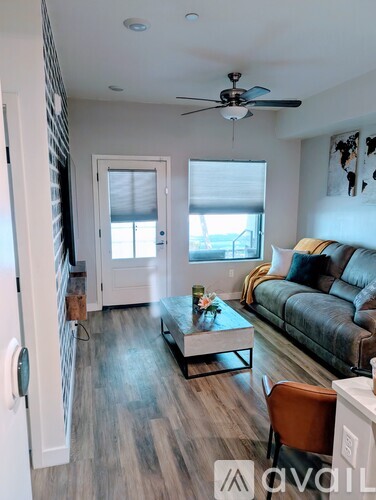 A living room with a couch, chair, and coffee table.