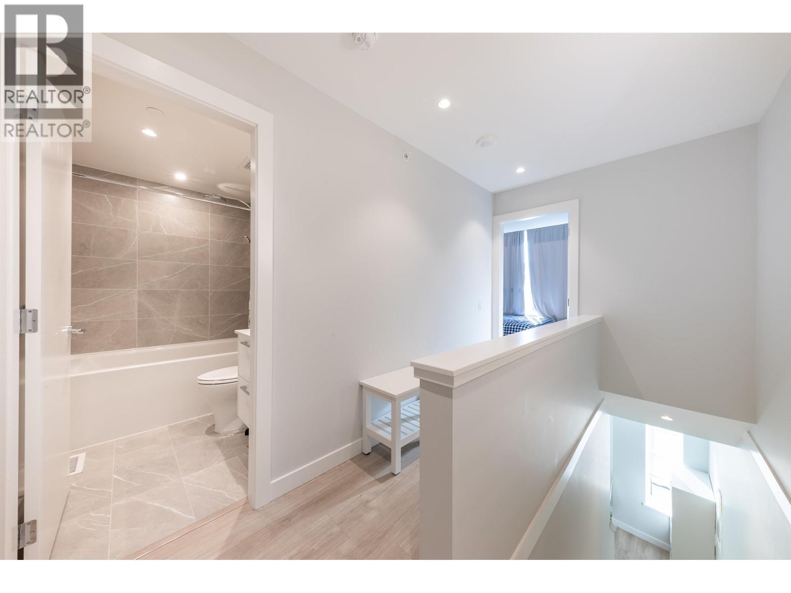A bathroom with a walk-in shower and a window.