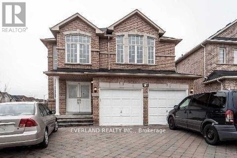 A brick house with a car parked in front of it.