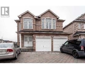 A brick house with a car parked in front of it.