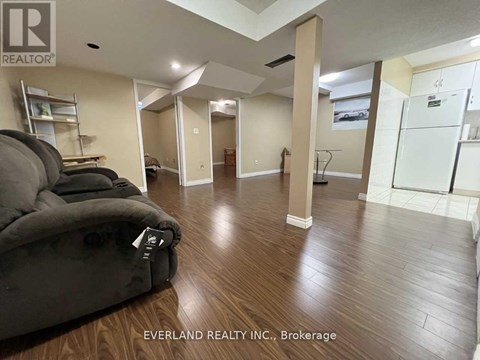 A living room with a couch and a chair in it.
