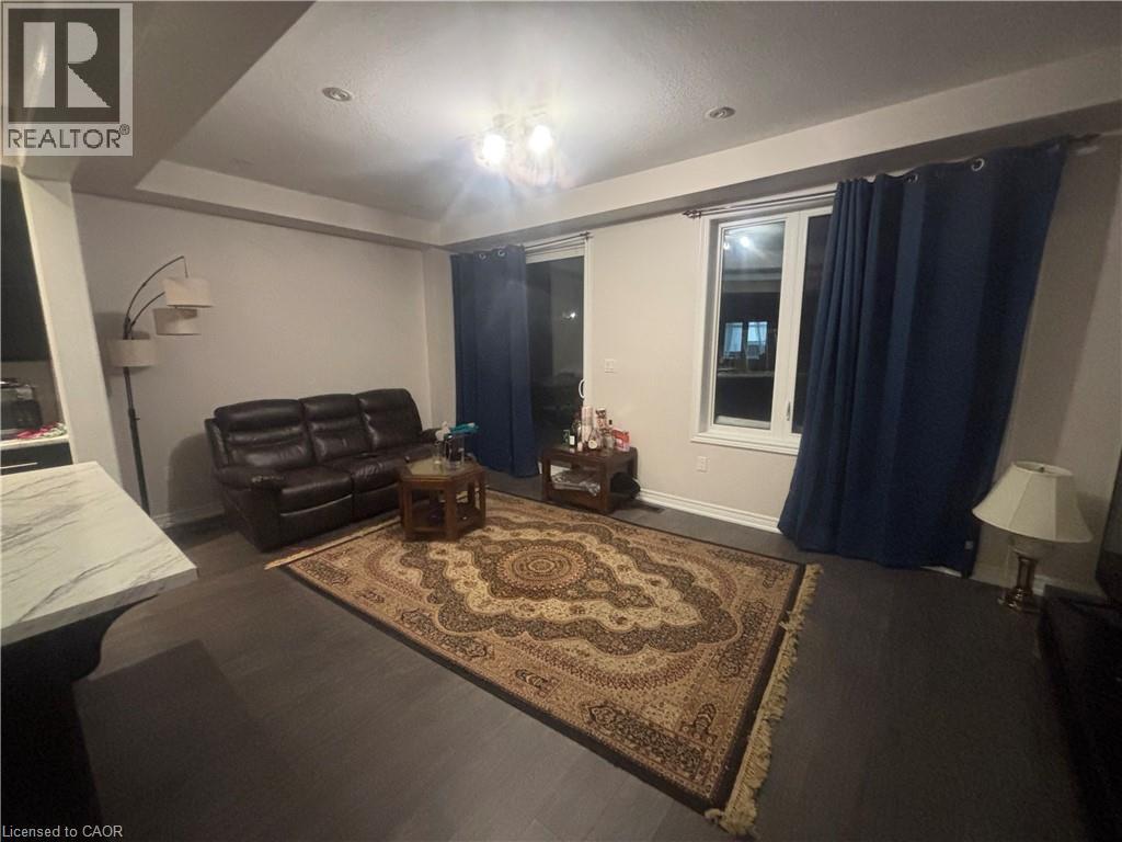 A living room with a brown rug and a brown leather chair.