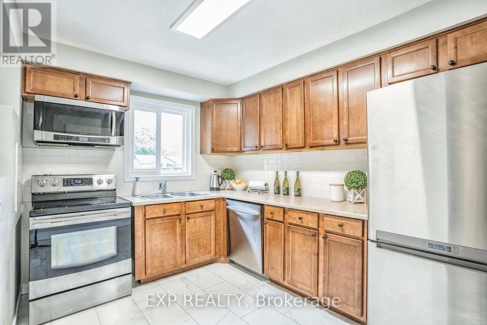 A kitchen with wooden cabinets and stainless steel appliances.