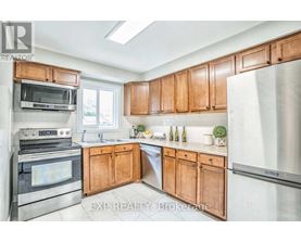 A kitchen with wooden cabinets and stainless steel appliances.