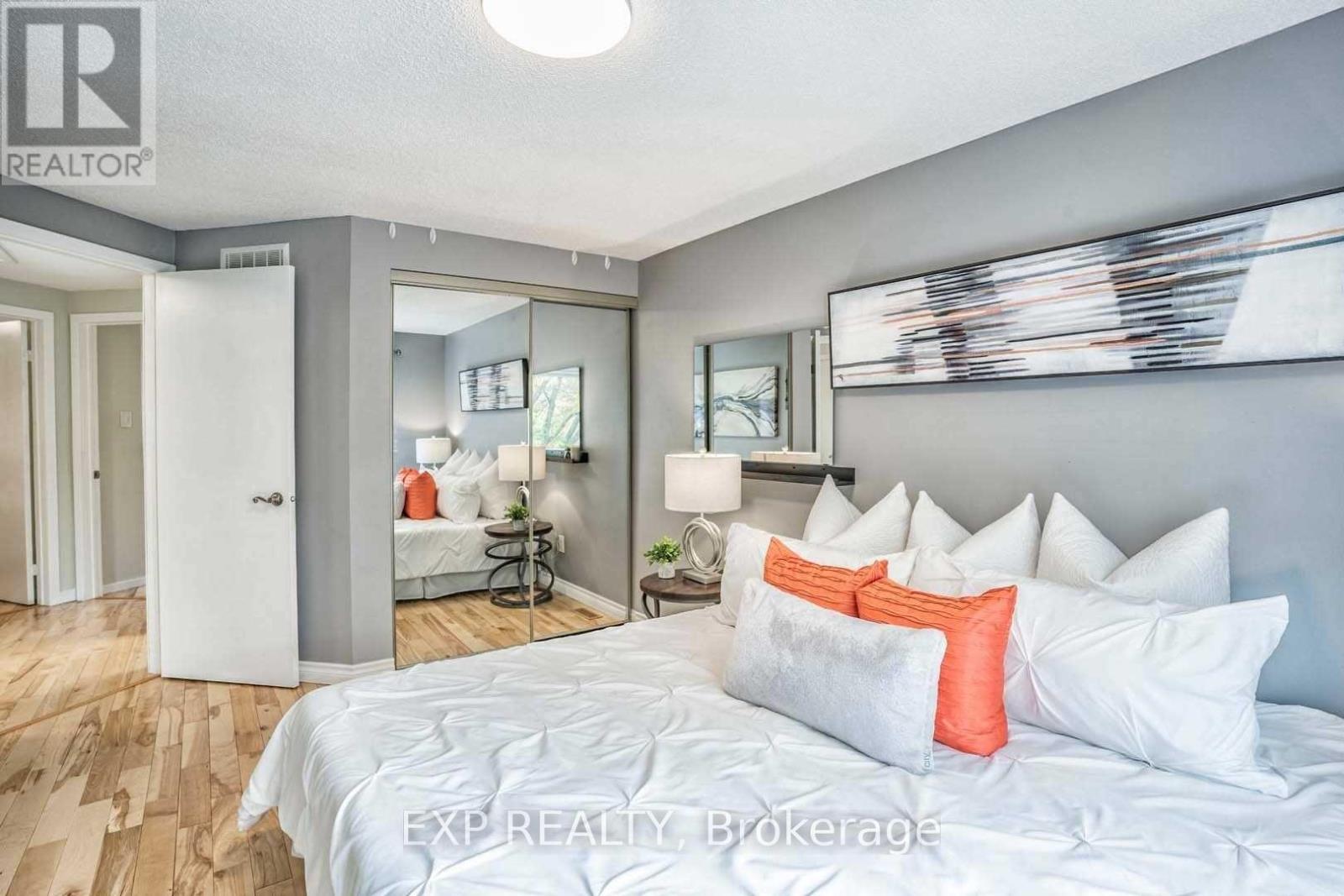 A bedroom with a large bed and a mirror on the wall.
