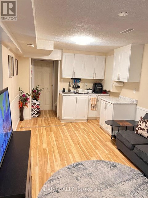 A living room with a grey couch and a television.