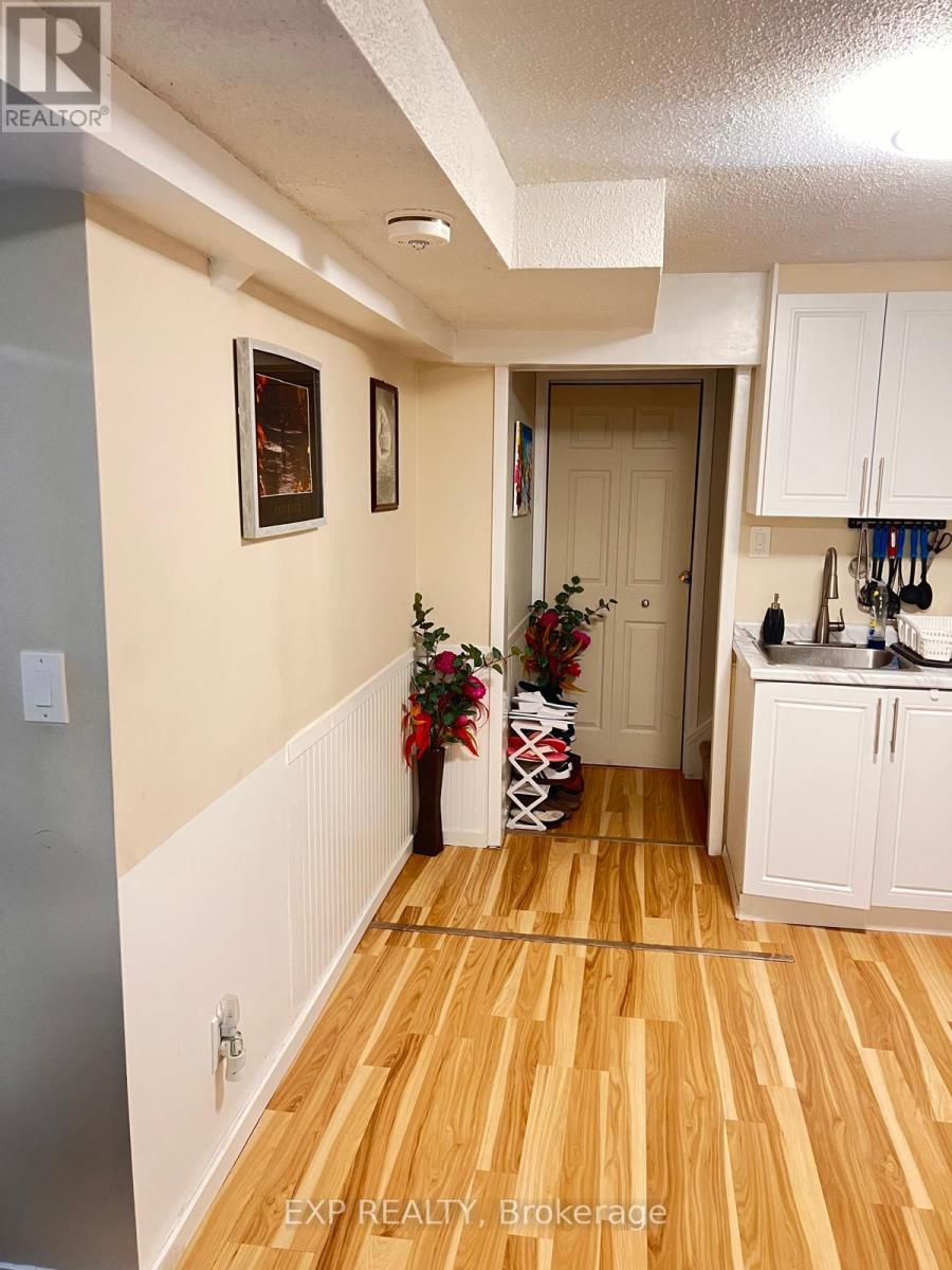 A hallway with a Christmas tree and vase on the floor.