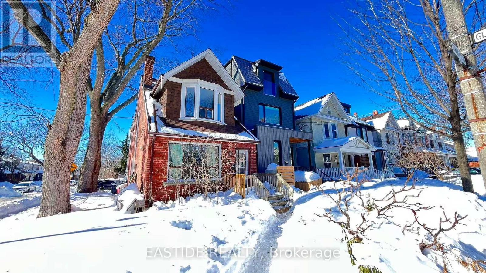 A house with a snow-covered front yard.