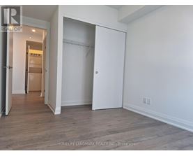 A room with a white wall and a wooden floor.