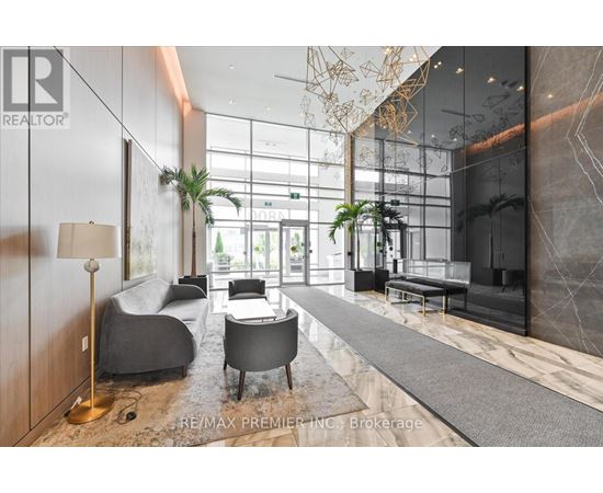 A modern living room with a grey sofa and a wooden floor.