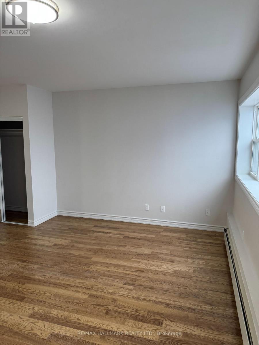 A room with wooden flooring and white walls.