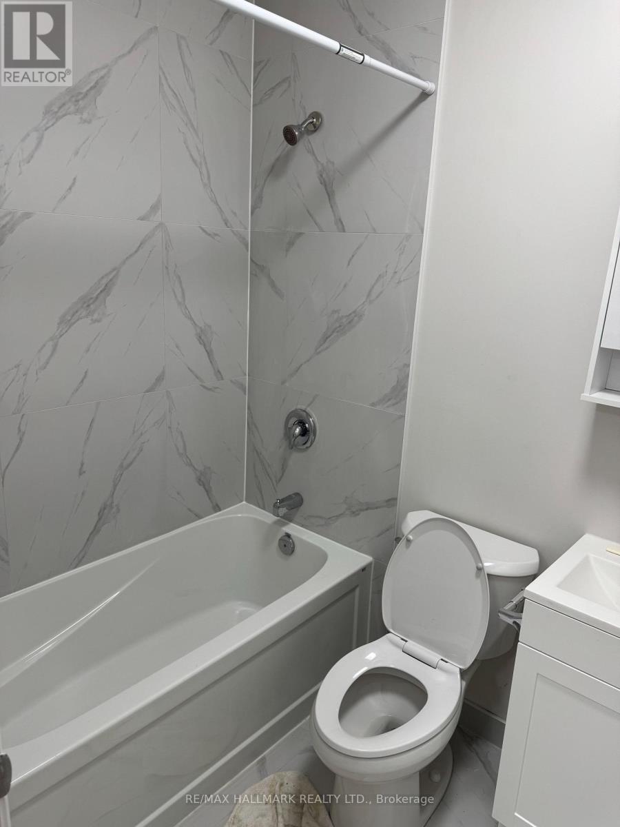 A white toilet in a bathroom with marble tiles.