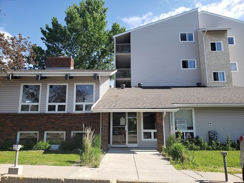 A two-story building with a garage on the bottom floor.