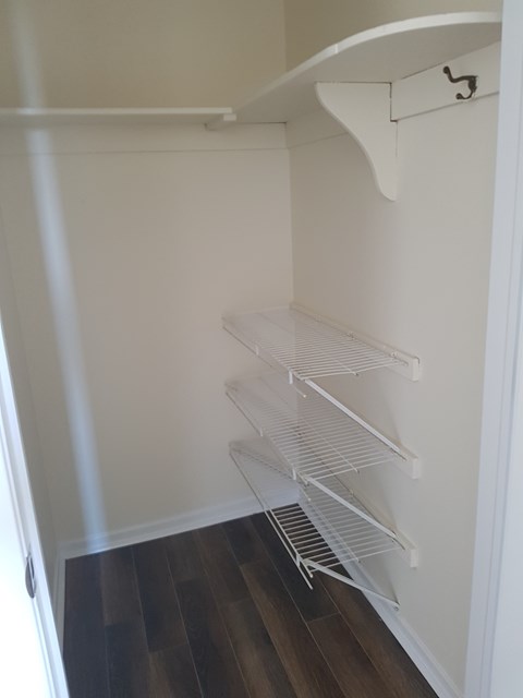 Empty white shelves in a room.