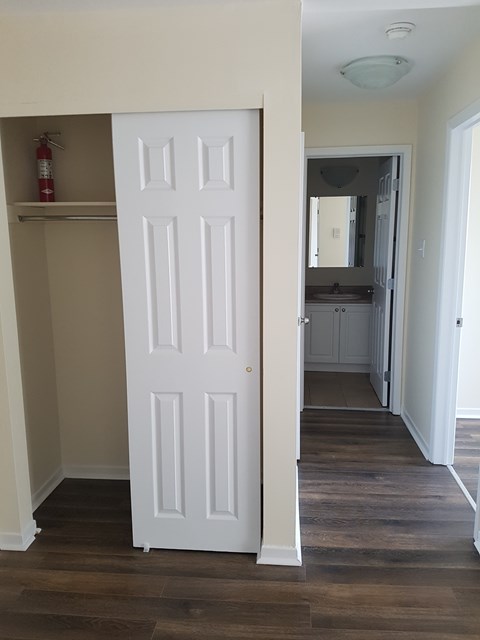 A white door is open to a hallway.