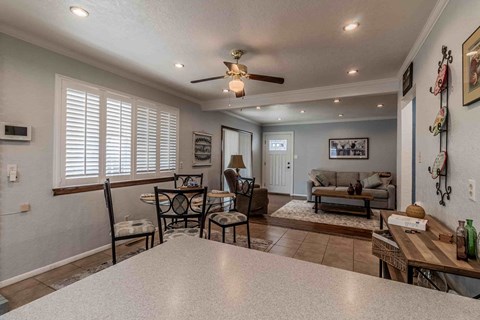 A living room with a dining table and chairs.