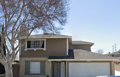 A house with a brown roof and a white garage door.
