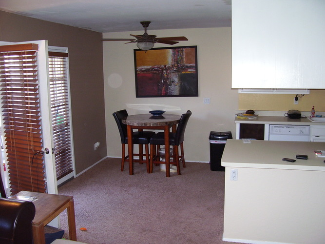 A dining room with a table and chairs.