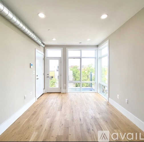 A room with wooden floors and a sliding glass door.