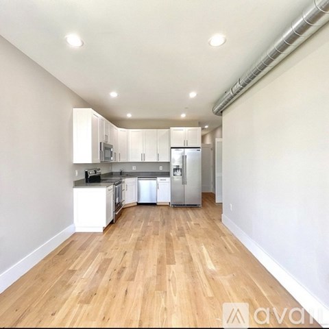 A kitchen with white cabinets and stainless steel appliances.