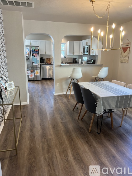 A dining room with a table set for four.