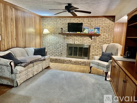 A living room with a fireplace and a couch.