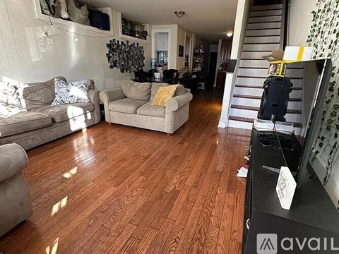 A living room with wooden floors and furniture.