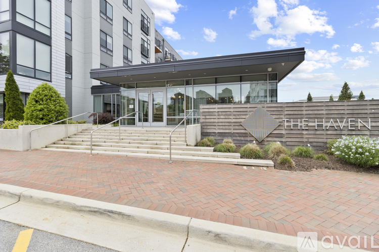 The Haven is a modern building with a glass entrance and a brick walkway leading up to it.