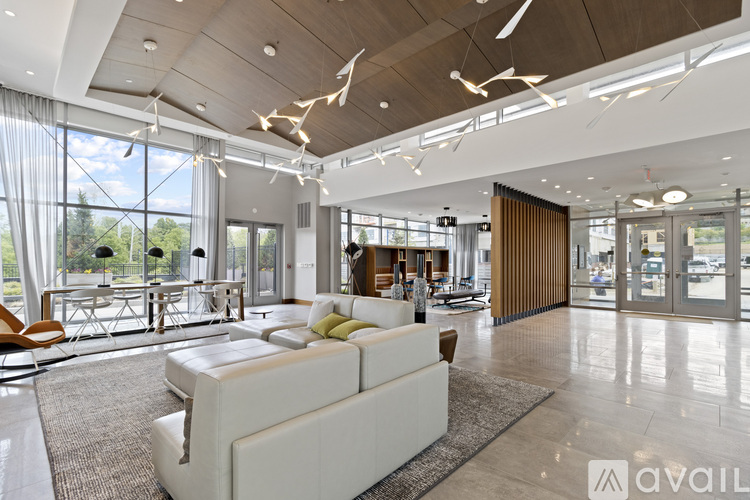 A spacious lobby with a white sofa and a wooden ceiling.
