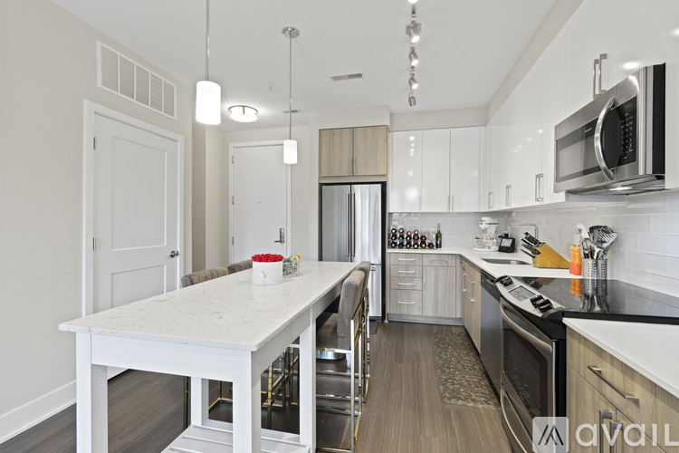 A kitchen with a white table and a white fridge.